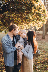 Fototapeta premium Family playing in autumn park having fun.