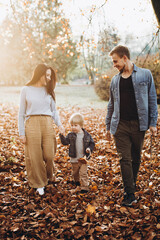Naklejka na ściany i meble happy family in autumn park
