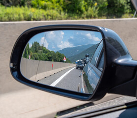 Traffic jam on European highway - lots of cars standing in the queue seen from the rearview mirror