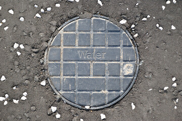 Close Up of Modern Plastic Inspection Cover  in Tarmac Pavement 