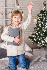 happy child reading a book at christmas