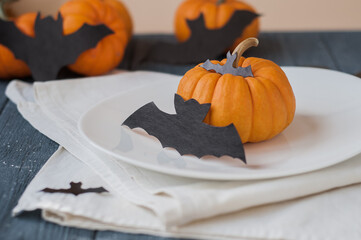 Elevated view of pumpkin, plate with halloween cookies, candies and cup with milk on wooden...