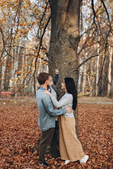 Fototapeta premium happy family mother father and baby on autumn walk in the park