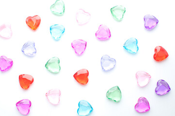 Multicolored hearts crystals on white background