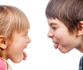 Children sticking out tongues