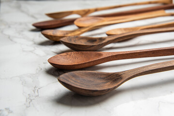 handmade wooden spoons on mable table