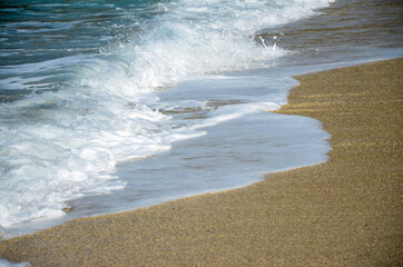Waves crashing on beach. Waves breaking on the shore. Coastline. Beautiful sandy beach at summer. Ocean horizon. Turquoise water of Ionian Sea. Vacation holidays. Mediterranean coast. Deep blue sea. 