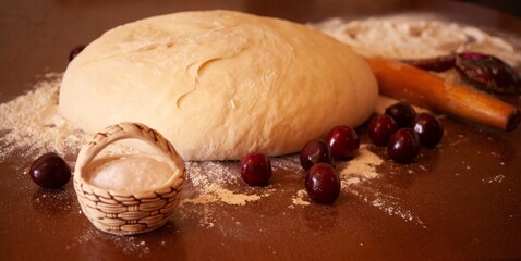 bread - pie with cherries on the table ready for baking