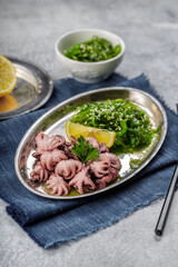 Traditional asian food. Delicious boiled octopus with fresh wakame salad.