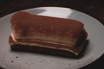 Photo of tiramisu cake close-up on a plate. Tasty food