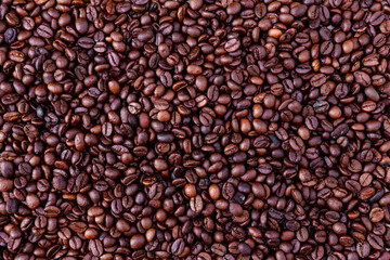 Freshly roasted coffee beans background. Coffee beans background. Background of roasted coffee beans.