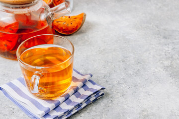 Bael fruit juice or quince tea and dried bael sliced fruit on light gray background. Thai or Asian healthy drink. Bael is helping the body to resist catching a cold