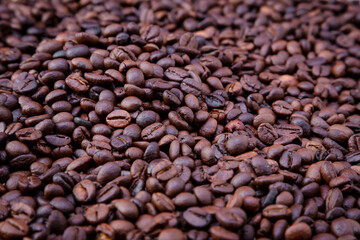 Freshly roasted coffee beans background. Coffee beans background. Background of roasted coffee beans.