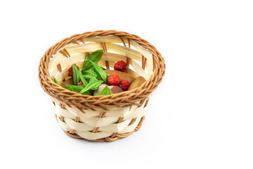 Fototapeta na wymiar Beautiful miniature full wicker basket on white isolated background, composition