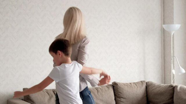 Mom and son have fun and dance. Mother - son relationship. Family