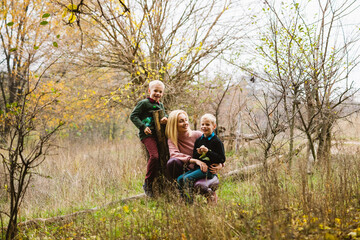 Naklejka na ściany i meble Happy family during walk in autumn forest