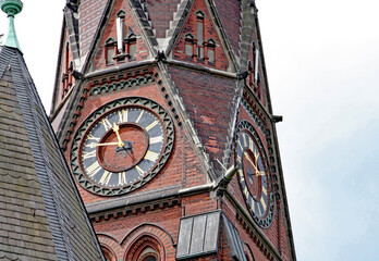 Closeup of a clock on a church tower in Hamburg, Germany.
