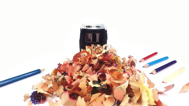 Sharpener for pencil. The camera travels to the sharpener through a pile of pencil shavings