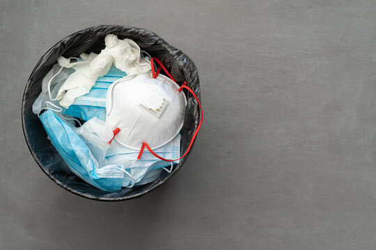 Used infectious masks and medical glove in the trash