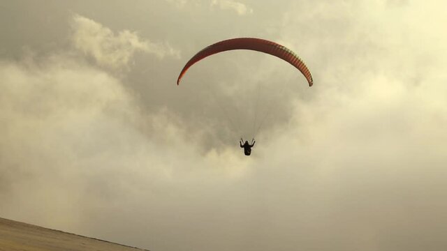 Silhouette man take off on paragliding at sunset. Paraglide flight experience skydive summer