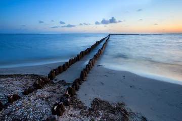 Fototapeten Pier long wooden breakwater in North sea  © Yay Images