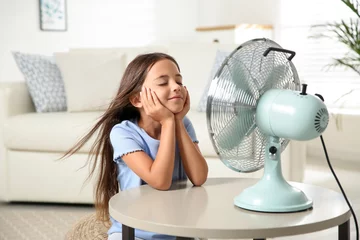 Foto op Plexiglas Little girl enjoying air flow from fan at home. Summer heat © New Africa