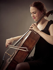 Smiling Cellist playing her old cello © Yay Images