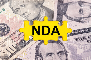 Puzzle with the image of dollars in the center of the inscription -NDA