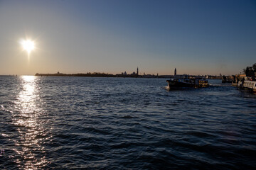 Fototapeta premium The sun sets over the Venetian lagoon and the distant San Giorgio Maggiore island 