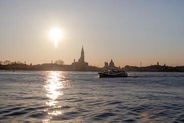 The setting sun beaming over the Venetian lagoon to the Church of San Giorgio Maggiore on the San Giorgio Maggiore island