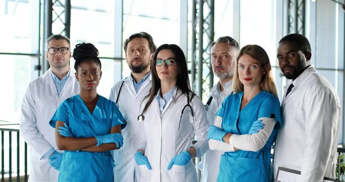 Portrait of multi ethnic women and men, doctors. International medics. Healthcare workers. Mixed-races physicians and nurses looking at camera. Clinic team. Docs at work in hospital.
