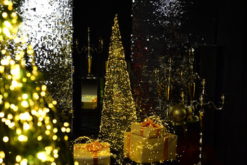 Obraz na płótnie Canvas New year background, miracle and gift wonder. Christmas tree decorated with festive lights. Winter holiday at home. Xmas design decoration.