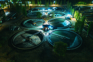 Aerial view at night wastewater treatment plant, filtration of dirty or sewage water.