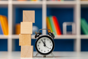 Four wooden cubes with copy space and alarm clock