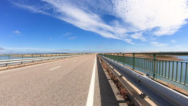 dolly move forward - M517 paved road (bridge) at the Alqueva water reservoir next to Mourao, Evora district, Alentejo, Portugal