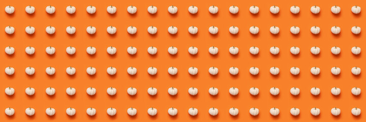 Halloween pumpkin with drop shadow pattern flat lay composition, white on orange background.
