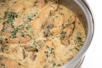 Creamy Herb Mushroom Chicken with steamed rice, dill and parsley preparing in the pan
