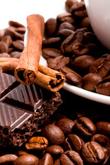 chocolate, coffee beans, cinnamon sticks and cup