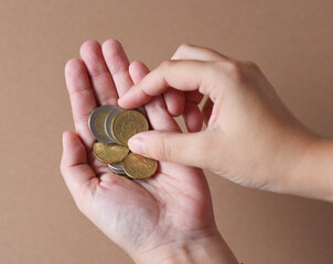 different coins in hands