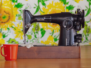 A vintage sewing machine with a 1970s backdrop with a retro filter applied.