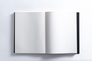 The book opens a blank white page, for use as a mockup sample design.