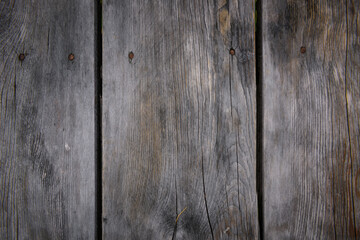 Wooden background. Gray vertical boards with rusty nails, close-up. Old tree, fragment of wall, abstract image.