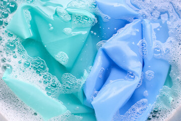 Color clothes soak in powder detergent water dissolution. Laundry concept