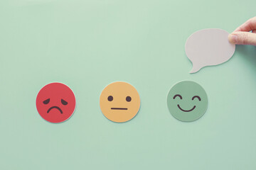 Hand holding speech bubble on happy smile face paper cut, good feedback rating and positive...