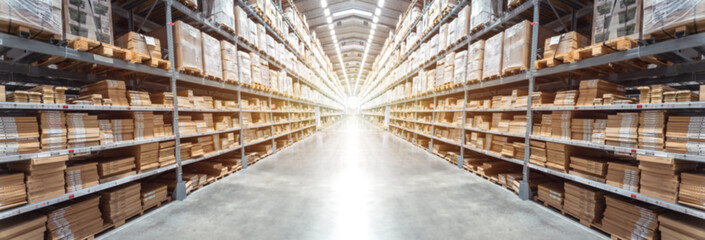 Abstract blurred background image of Panorama Rows of shelves with goods boxes in modern industry warehouse store at factory warehouse storage for logistic