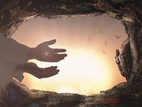 Ascension day concept: The scars In the hands of Jesus Christ over tombstone sunrise background