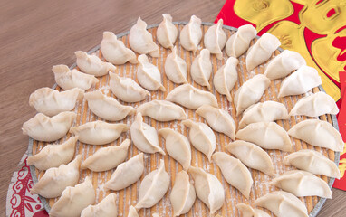 The tray is full of neatly packed dumplings