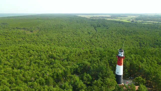 Aerial View Of The Stilo Lighthouse Surrounded By Lush Green Foliage In Osetnik, Poland, On The Polish Coast Of The Baltic Sea - drone shot