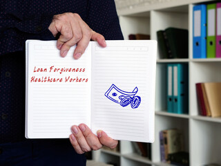 Business concept about Loan Forgiveness Healthcare Workers with phrase on the piece of paper.