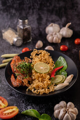 Crab Tom Yum Mama with Lemon, Chili, Tomato, Garlic, Lemongrass, Kaffir Lime Leaves on the plate